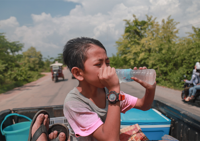 a-cambodian-boy-is-drinking-ice-water-on-a-sunny-day